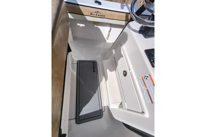 Slide: The Image of 2024 Sea Chaser 24 HFC boat interior with SeaDek flooring and steering wheel. - 54