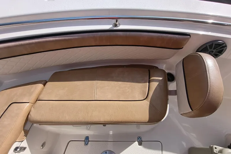 Slide: The Image of 2024 Sea Chaser 24 HFC boat interior with tan leather seating and speaker. - 57