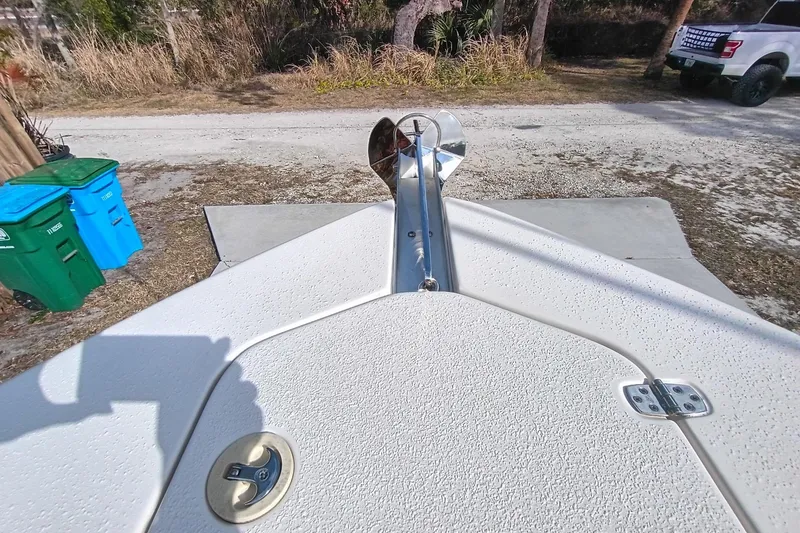Slide: The Image of 2024 Sea Chaser 24 HFC boat bow with anchor, parked near recycling bins and truck. - 59