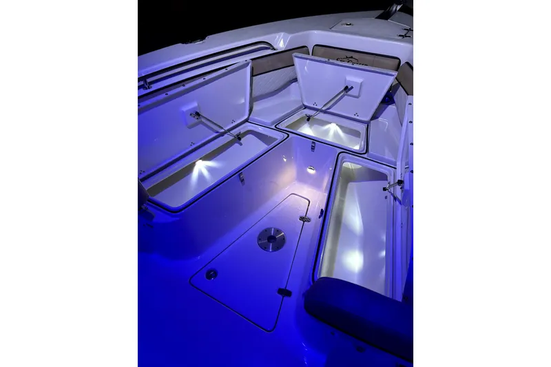 Slide: The Image of 2024 Sea Chaser 24 HFC boat with dual Suzuki engines, open storage compartments. - 63