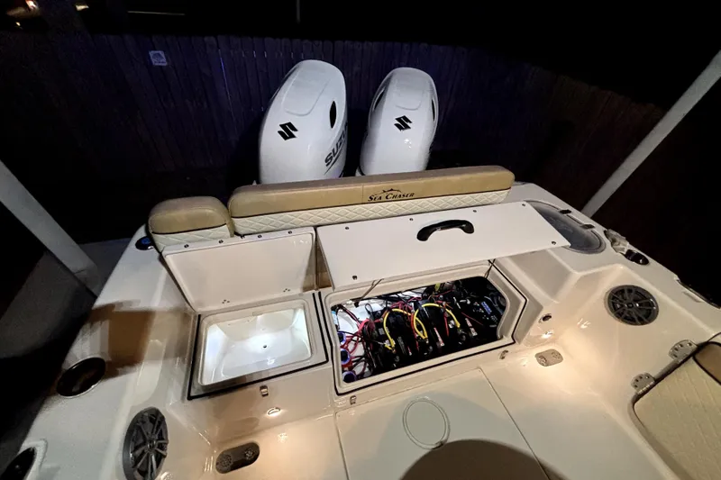 Slide: The Image of 2024 Sea Chaser 24 HFC boat interior at night, featuring spacious seating and storage. - 64