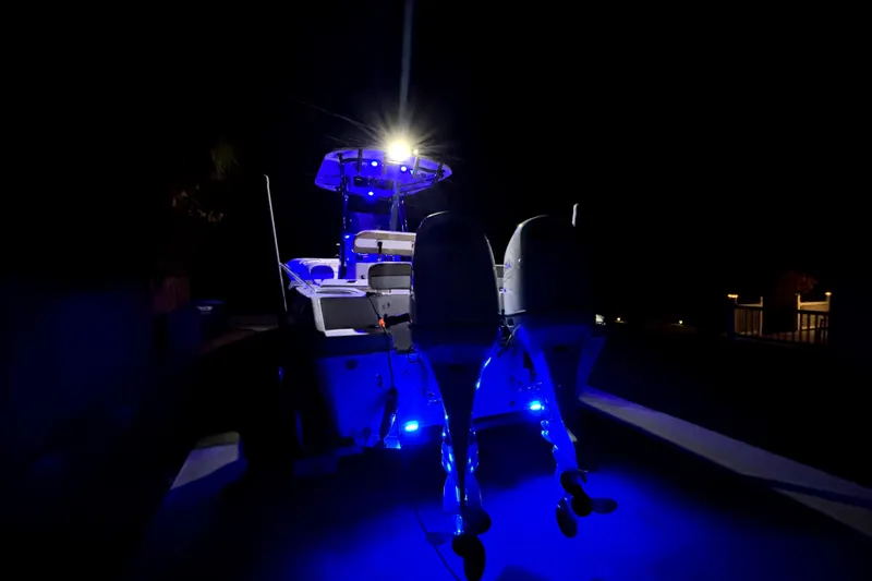 Slide: The Image of 2024 Sea Chaser 24 HFC boat interior with blue LED lighting at night. - 66