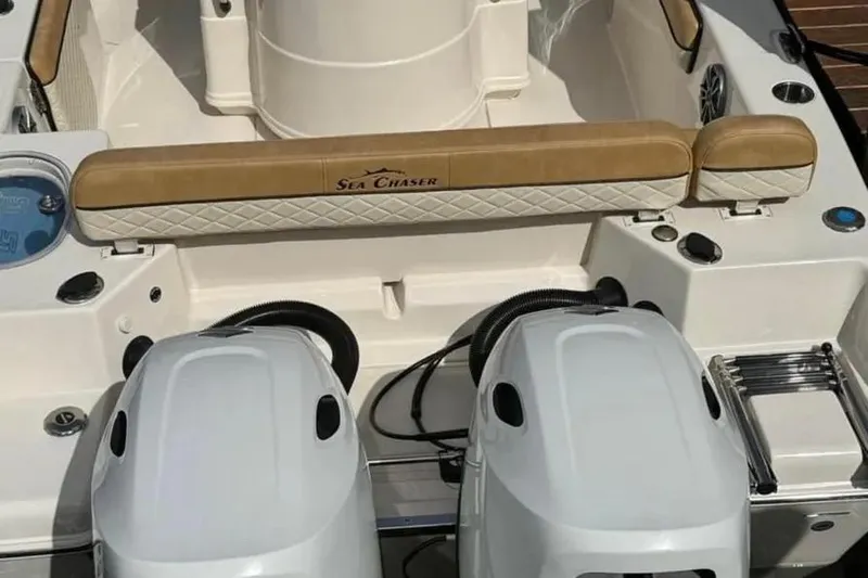 Slide: The Image of 2024 Sea Chaser 24 HFC boat with Suzuki outboard motor, parked outdoors. - 7