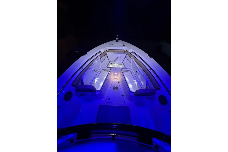 Slide: The Image of 2024 Sea Chaser 24 HFC boat console with blue LED lighting and modern controls. - 70