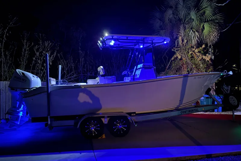 Slide: The Image of 2024 Sea Chaser 24 HFC boat dashboard with illuminated controls and dual screens. - 75