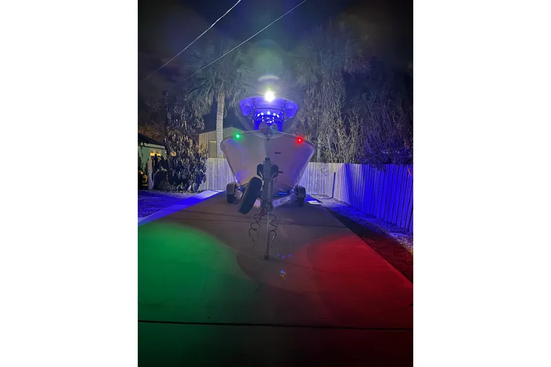 Slide: The Image of 2024 Sea Chaser 24 HFC boat interior with illuminated storage compartments at night. - 76