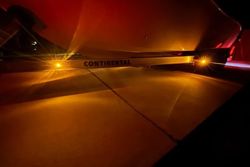 Slide: The Image of Illuminated underside of 2024 Sea Chaser 24 HFC boat on Continental trailer at night. - 78