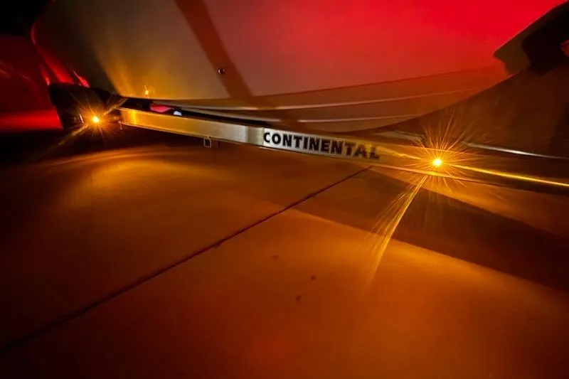 Slide: The Image of 2024 Sea Chaser 24 HFC on Continental trailer, illuminated at night. - 79