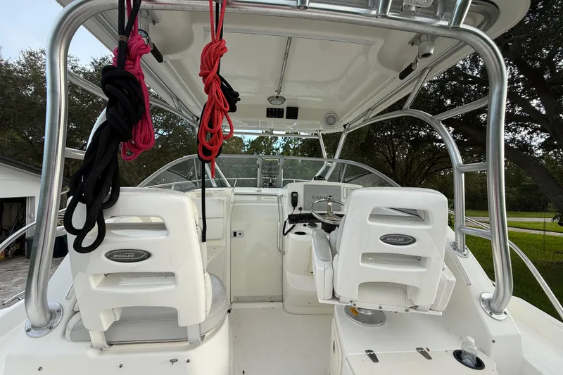 Slide: The Image of Person opening storage compartment on 2011 Boston Whaler 285 Conquest boat. - 15