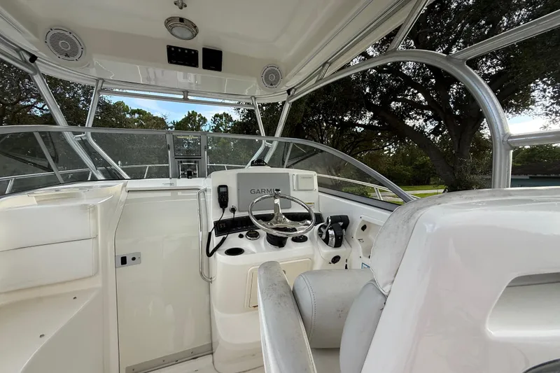 Slide: The Image of 2011 Boston Whaler 285 Conquest dashboard with switches and Garmin device. - 19