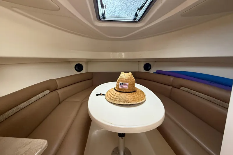 Slide: The Image of 2011 Boston Whaler 285 Conquest interior kitchen with sink, stove, and microwave. - 26