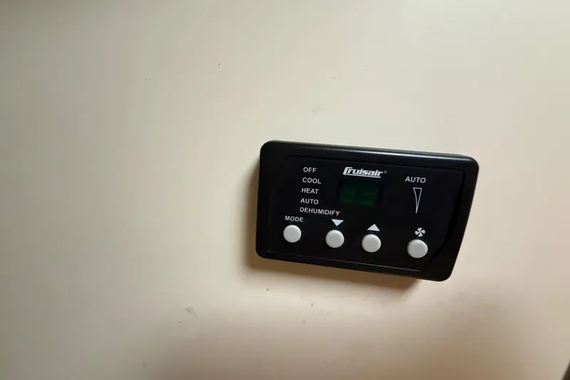 Slide: The Image of 2011 Boston Whaler 285 Conquest bathroom with sink, storage cabinets, and porthole window. - 29