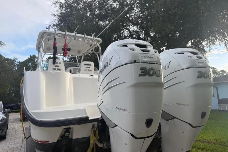 Slide: The Image of 2011 Boston Whaler 285 Conquest boat with seating, under a partly cloudy sky. - 3