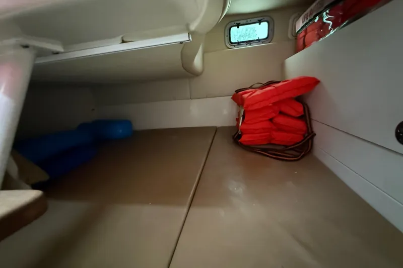 Slide: The Image of Interior of 2011 Boston Whaler 285 Conquest boat with seating, table, and kitchenette. - 31