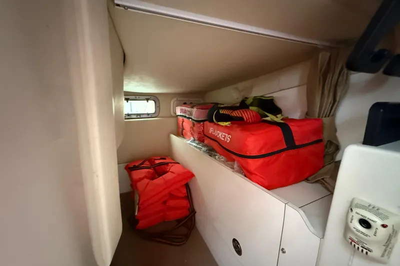 Slide: The Image of Interior of 2011 Boston Whaler 285 Conquest with wall-mounted TV and cabin view. - 32