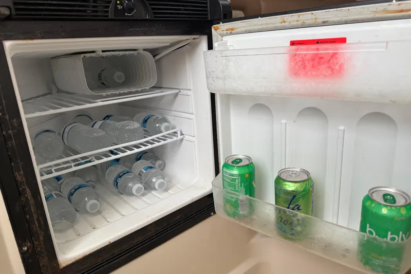 Slide: The Image of Interior of 2011 Boston Whaler 285 Conquest with cushioned seating and built-in speakers. - 34