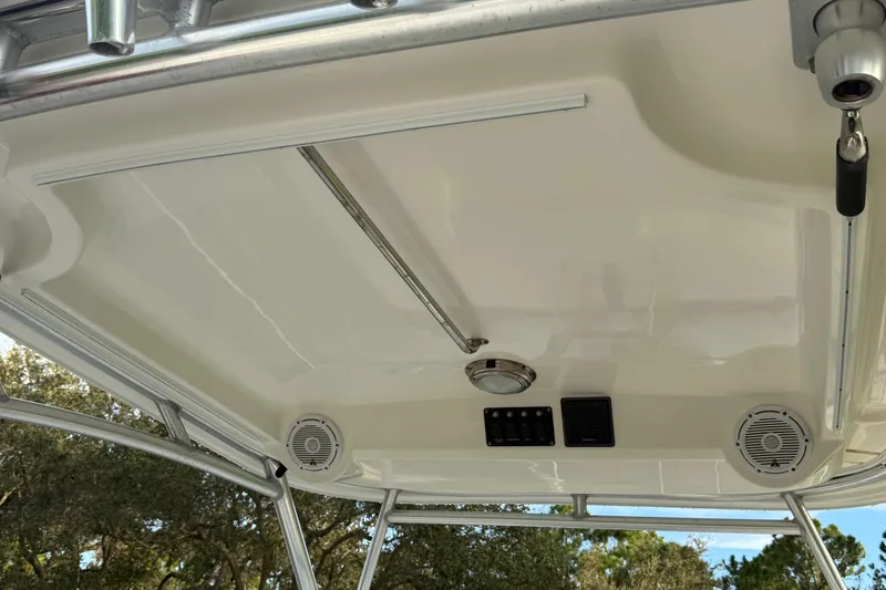 Slide: The Image of 2011 Boston Whaler 285 Conquest boat deck with clear sky and trees in background. - 38