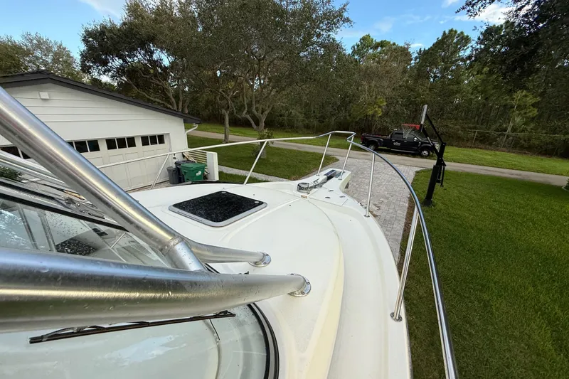 Slide: The Image of 2011 Boston Whaler 285 Conquest boat with hardtop and windshield, docked outdoors. - 39