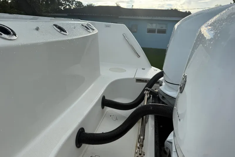 Slide: The Image of 2011 Boston Whaler 285 Conquest boat interior with seating and helm, docked outdoors. - 4