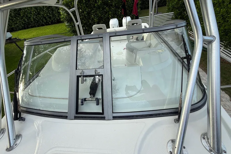 Slide: The Image of 2011 Boston Whaler 285 Conquest with twin 300 Verado engines, parked outdoors. - 45
