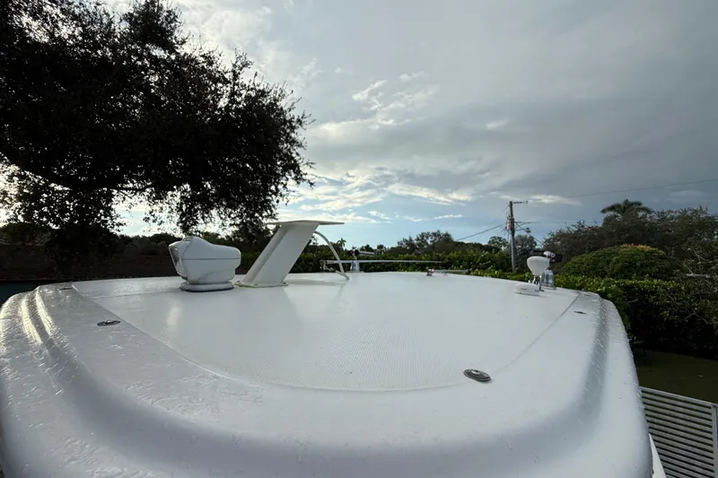 Slide: The Image of 2011 Boston Whaler 285 Conquest boat with dual Mercury engines, parked on grass. - 46