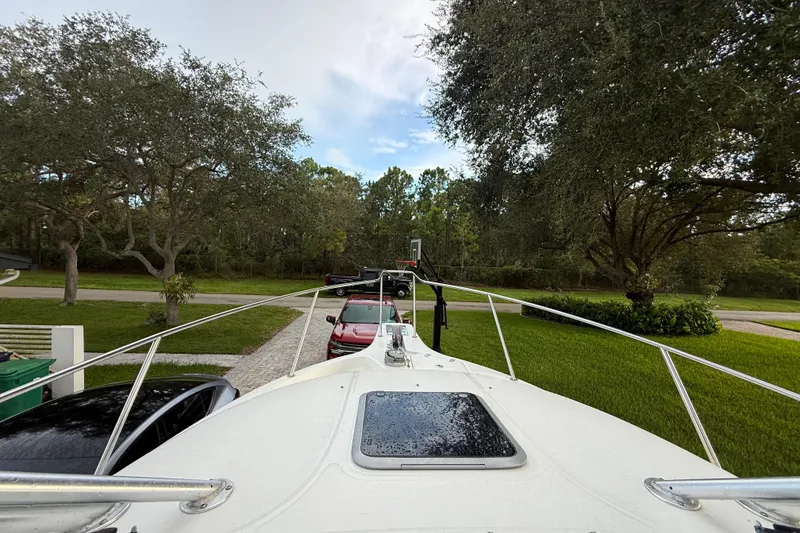 Slide: The Image of 2011 Boston Whaler 285 Conquest on trailer, showing outboard motor and hull details. - 47