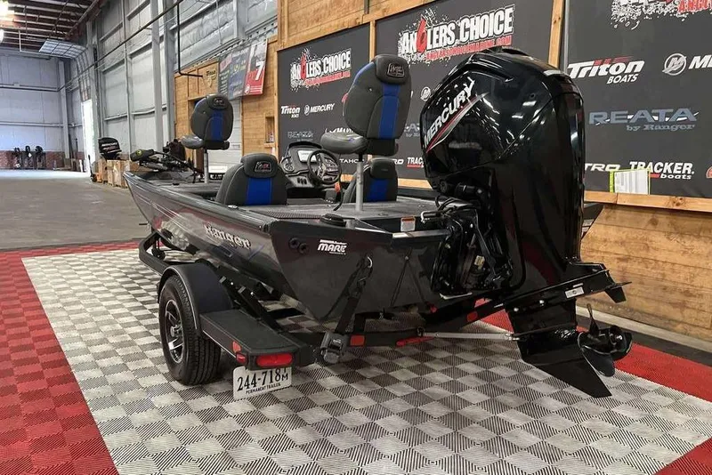 Slide: The Image of 2022 Ranger RT178 boat with Mercury engine displayed indoors on checkered flooring. - 4