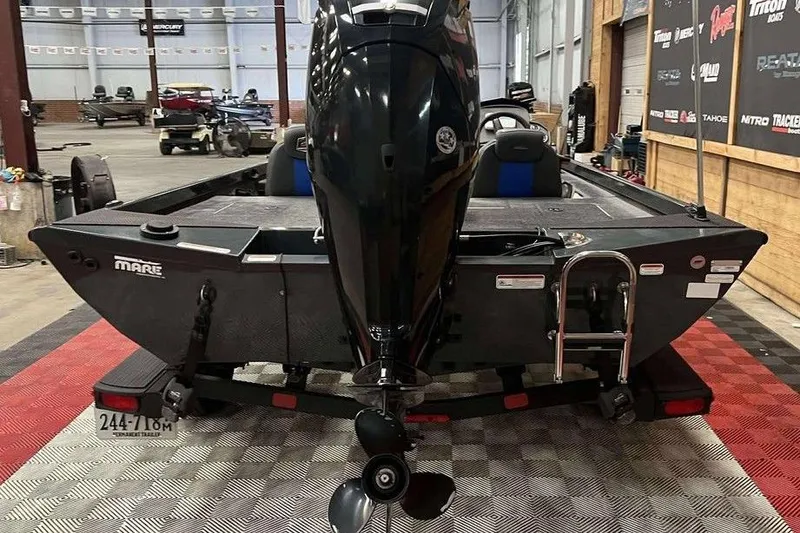 Slide: The Image of 2022 Ranger RT178 boat in a garage, showcasing rear view and motor. - 5