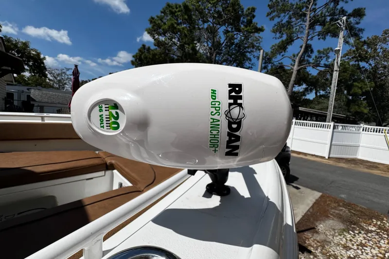 Slide: The Image of 2022 Sea Hunt Ultra 255 SE boat on calm water under clear blue sky. - 11