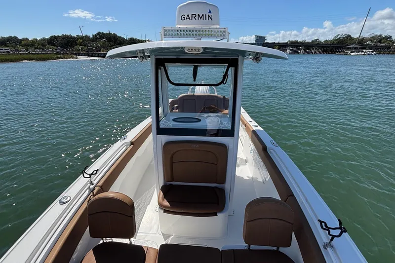 Slide: The Image of 2022 Sea Hunt Ultra 255 SE boat on water, featuring Garmin navigation system. - 14