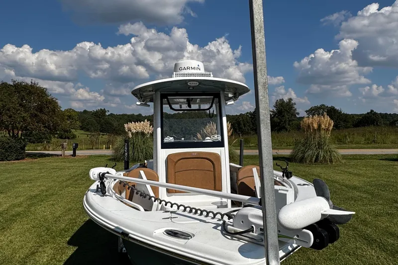 Slide: The Image of 2022 Sea Hunt Ultra 255 SE boat on trailer, surrounded by lush greenery. - 5