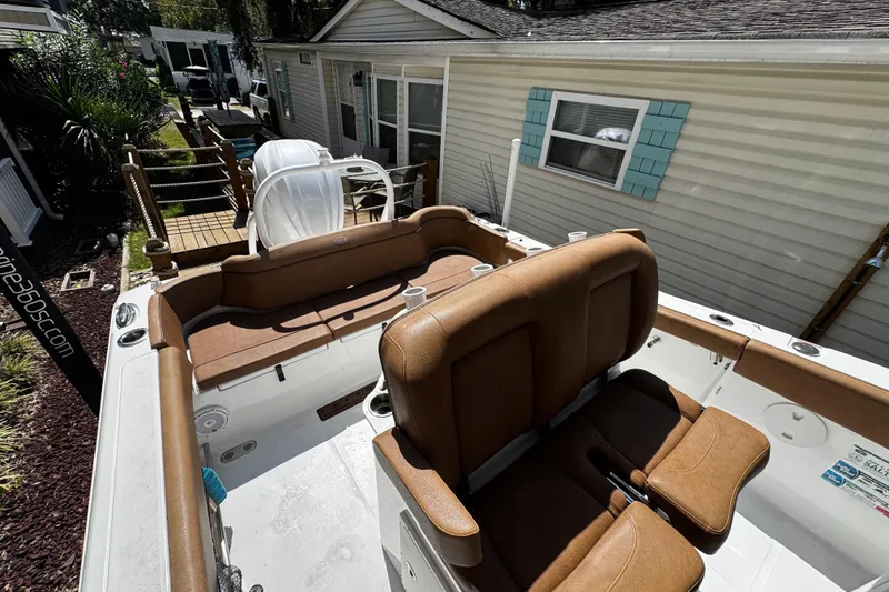 Slide: The Image of 2022 Sea Hunt Ultra 255 SE boat on water, featuring sleek design and comfortable seating. - 9