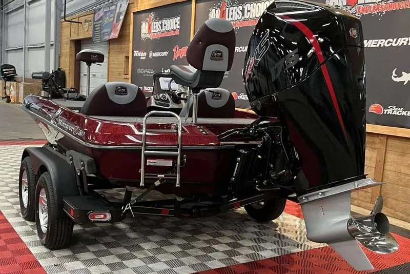 Slide: The Image of 2026 Ranger Z185 boat with powerful outboard motor on display indoors. - 3