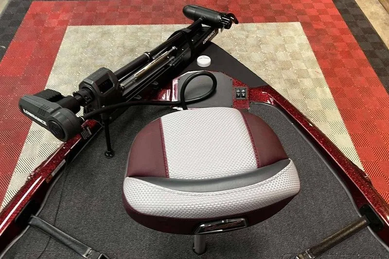 Slide: The Image of 2026 Ranger Z185 boat seat and trolling motor on patterned flooring. - 5