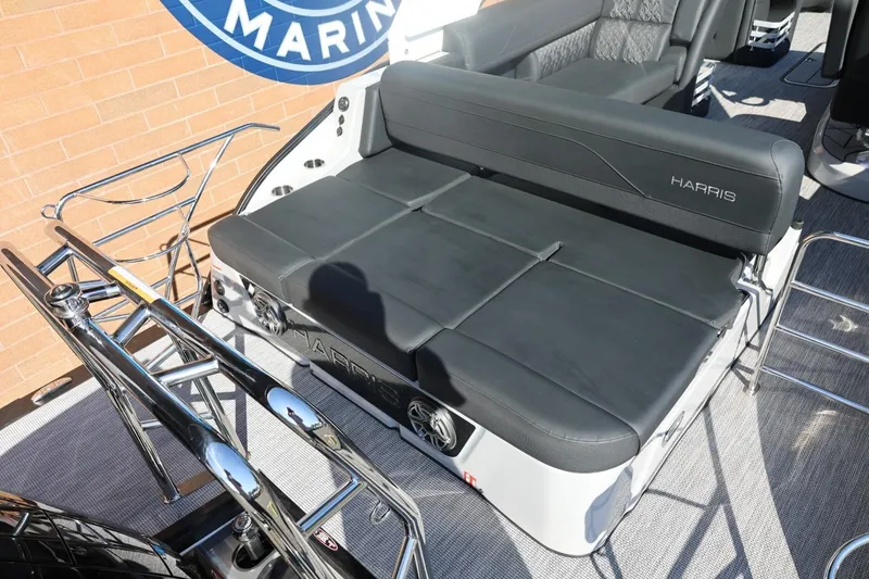 Slide: The Image of 2026 Harris Grand Mariner 250 interior with storage compartments and sleek seating design. - 17