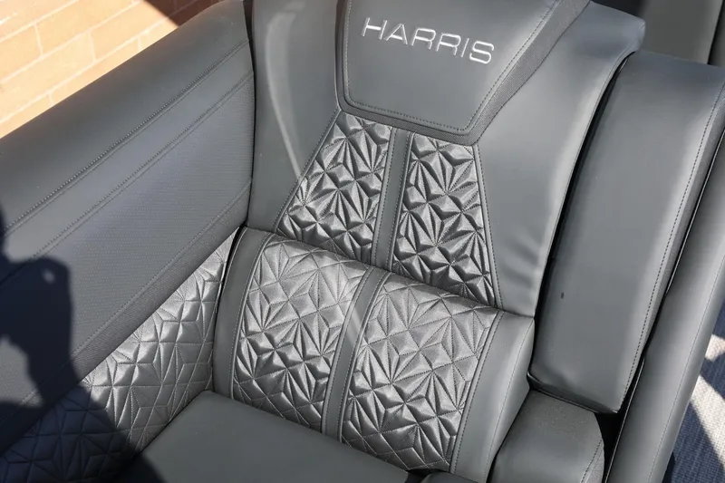 Slide: The Image of 2026 Harris Grand Mariner 250 dashboard with dual screens and modern steering wheel. - 26