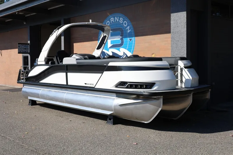 Slide: The Image of 2026 Harris Grand Mariner 250 pontoon boat displayed outdoors. - 3