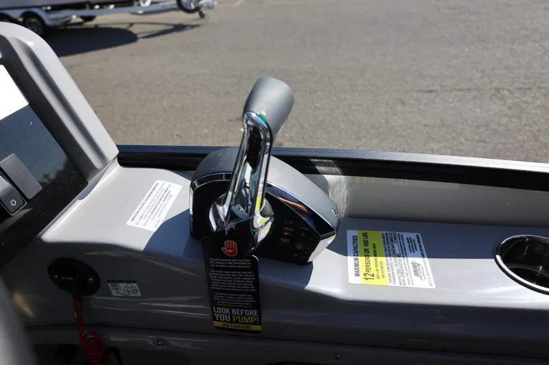 Slide: The Image of 2026 Harris Grand Mariner 250 interior with built-in storage compartment and seating. - 31