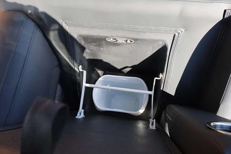 Slide: The Image of 2026 Harris Grand Mariner 250 interior storage compartments with quilted upholstery and cup holders. - 38