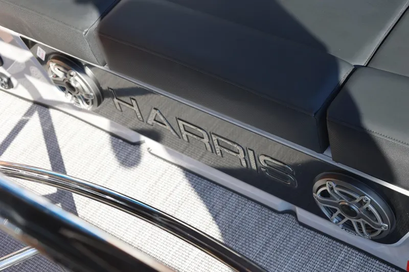 Slide: The Image of 2026 Harris Grand Mariner 250 pontoon boat with powerful outboard motor, parked on trailer. - 51