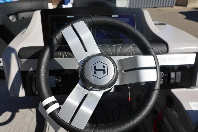 Slide: The Image of 2026 Harris Grand Mariner 250 pontoon boat on trailer, close-up view. - 55