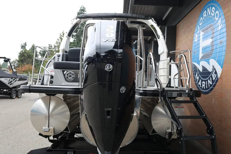 Slide: The Image of 2026 Harris Grand Mariner 250 boat with powerful outboard motor at a marina. - 59