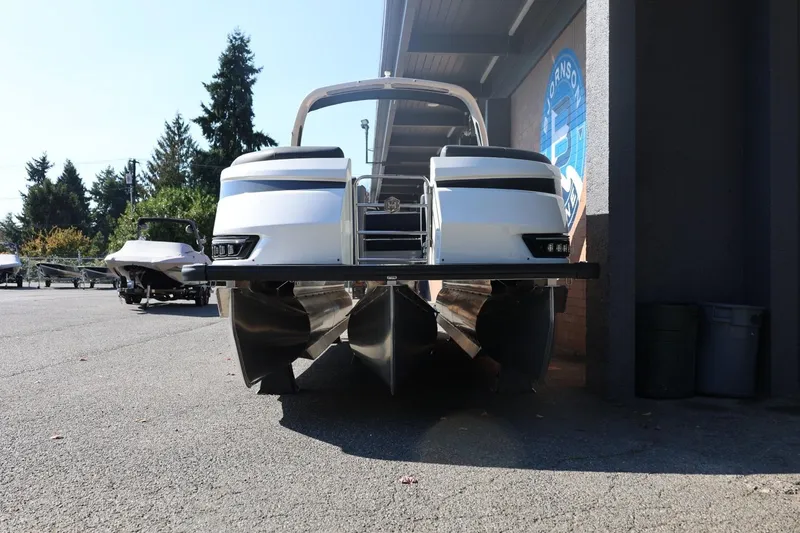 Slide: The Image of 2026 Harris Grand Mariner 250 pontoon boat parked outdoors, front view. - 6