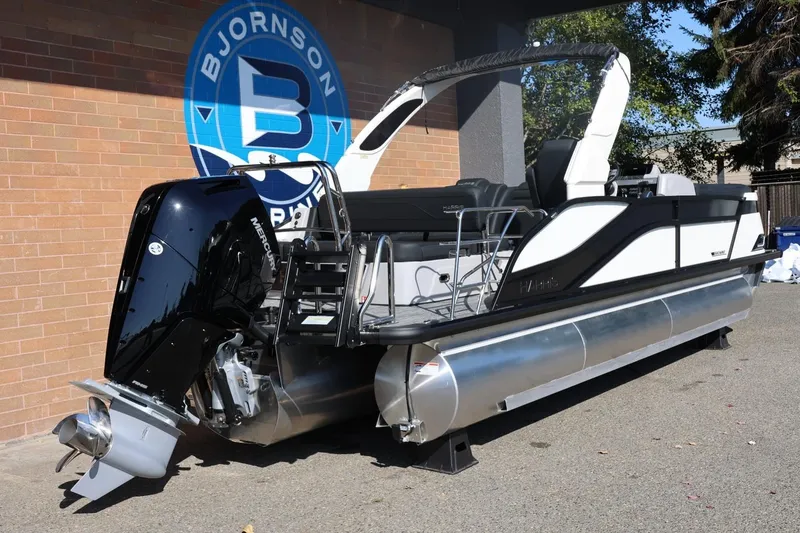Slide: The Image of 2026 Harris Grand Mariner 250 pontoon boat with Mercury engine, displayed outdoors. - 7