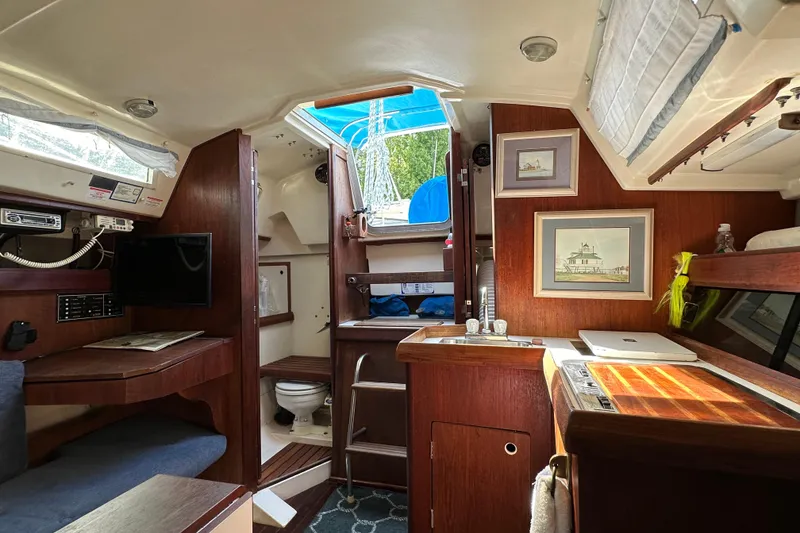 Slide: The Image of Interior of 1985 Hunter 28.5 sailboat with cozy cabin and nautical decor. - 11