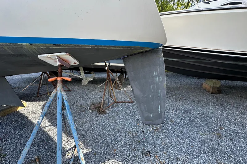 Slide: The Image of Hunter 28.5 sailboat from 1985 on stands, showing keel and hull details. - 17