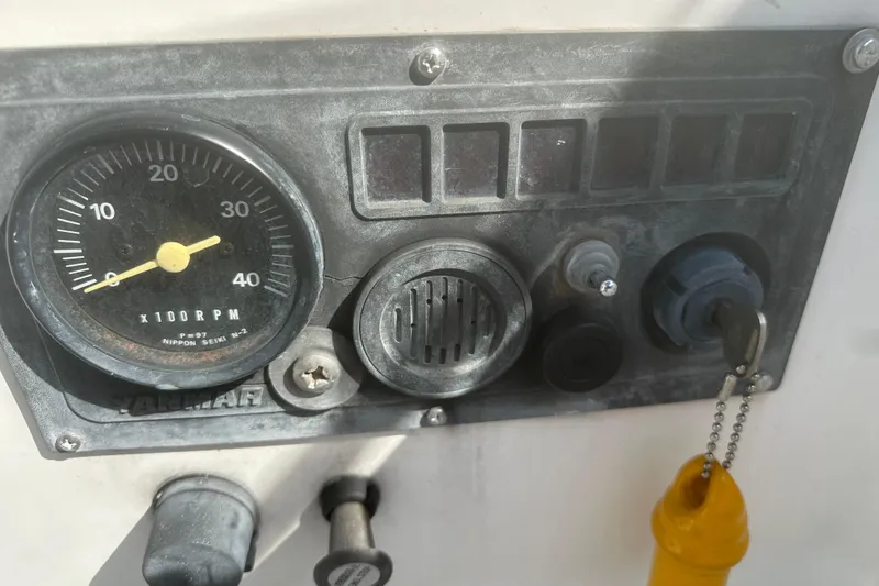 Slide: The Image of Control panel of a 1985 Hunter 28.5 sailboat with RPM gauge and ignition key. - 6