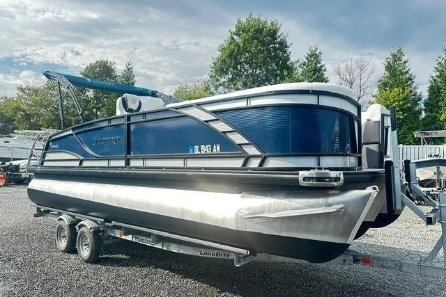 The Image of 2021 Godfrey Monaco 235RL Tri Toon boat on trailer, parked outdoors. - 0