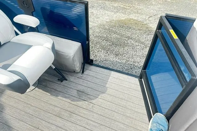 Slide: The Image of 2021 Godfrey Monaco 235RL Tri Toon interior with seating and open door, showcasing modern design. - 12