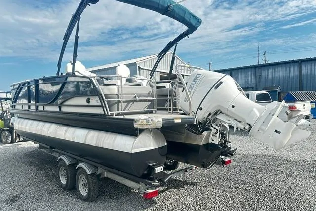 Slide: The Image of 2021 Godfrey Monaco 235RL Tri Toon boat on trailer, parked outdoors. - 2
